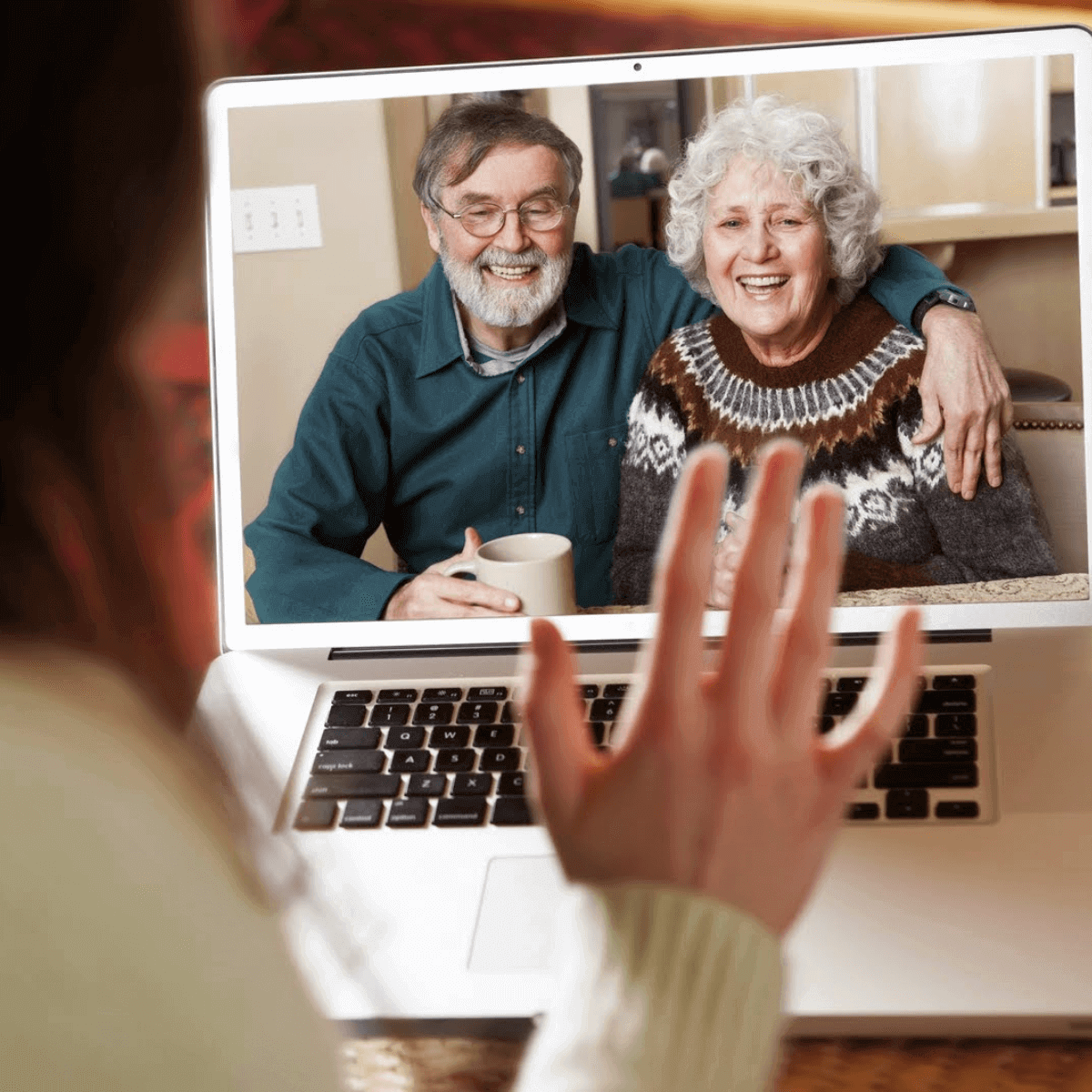 Woman talking to family on laptop