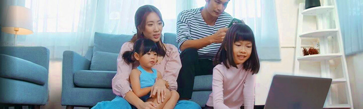 Asian family around a shared laptop